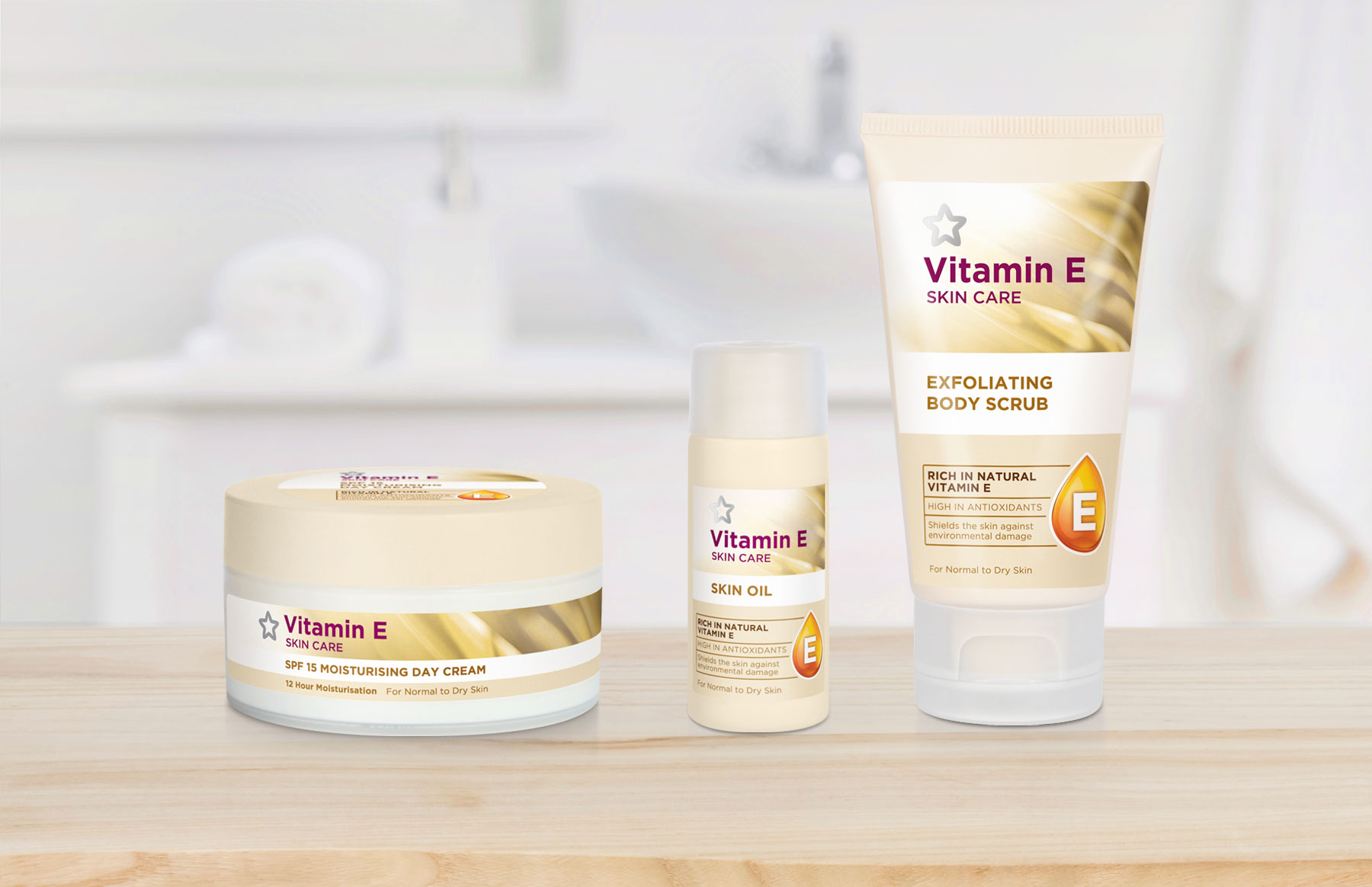 Superdrug Vitamin E products lined up on a bathroom counter with blurred out bathroom in the background design by Biles Hendry